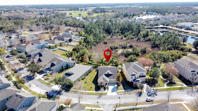 birds eye view of property with a water view and a residential view