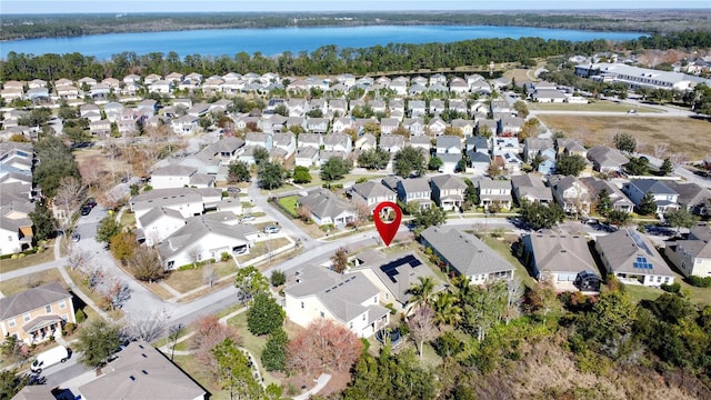 birds eye view of property with a water view and a residential view