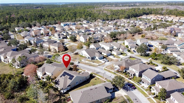 aerial view featuring a residential view and a wooded view