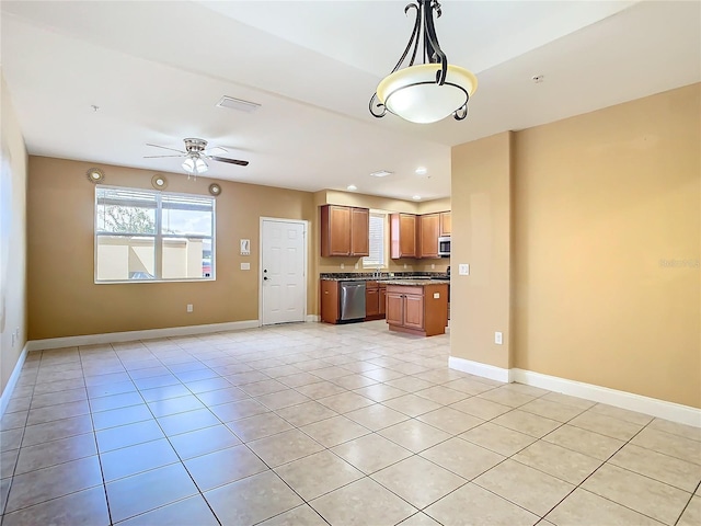 kitchen featuring appliances with stainless steel finishes, sink, hanging light fixtures, ceiling fan, and light tile patterned floors