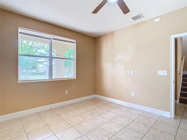 unfurnished room featuring ceiling fan and light tile patterned floors