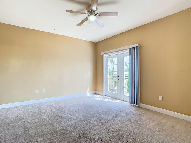 carpeted empty room featuring ceiling fan and french doors