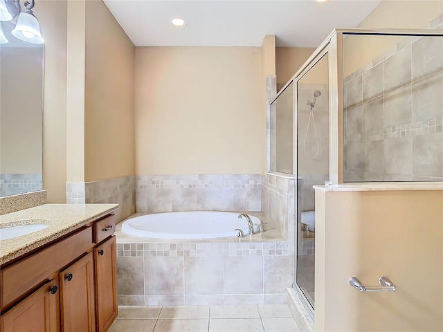 bathroom with separate shower and tub, vanity, and tile patterned floors