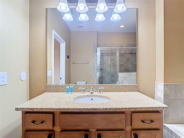 bathroom featuring toilet, a shower with door, and sink