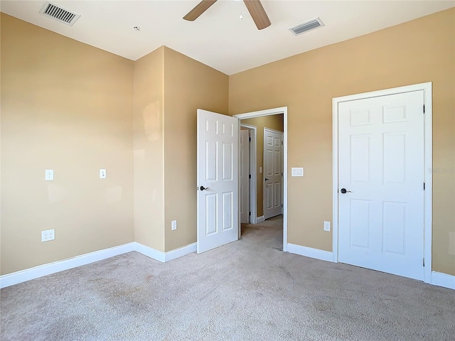 unfurnished bedroom featuring ceiling fan and light carpet