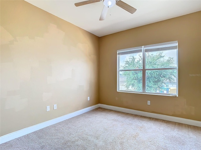 carpeted empty room featuring ceiling fan