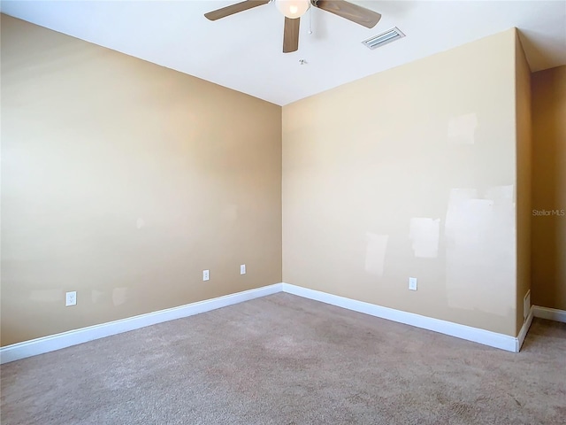 empty room featuring ceiling fan and carpet flooring