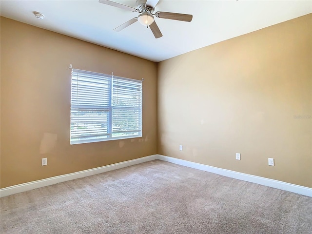 carpeted spare room with ceiling fan