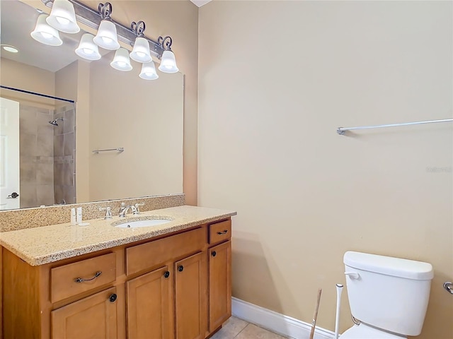 bathroom featuring toilet, vanity, tile patterned flooring, and tiled shower