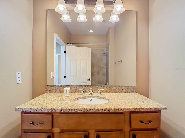 bathroom with walk in shower and vanity