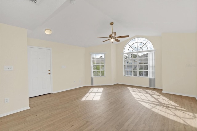 unfurnished room with ceiling fan, light hardwood / wood-style flooring, and lofted ceiling