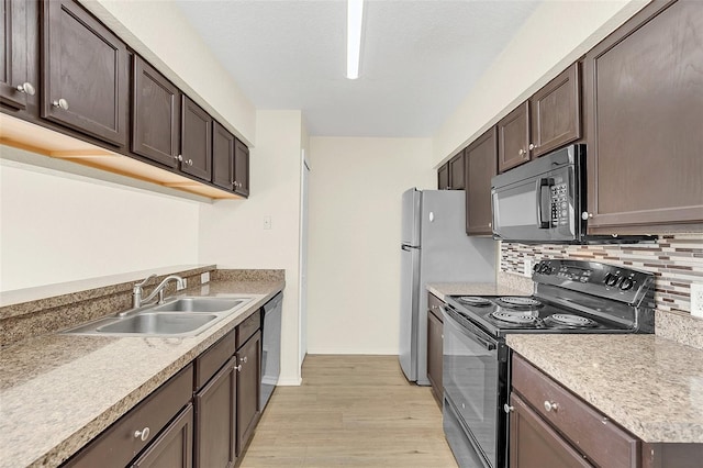 kitchen featuring dark brown cabinetry, black appliances, decorative backsplash, sink, and light hardwood / wood-style floors