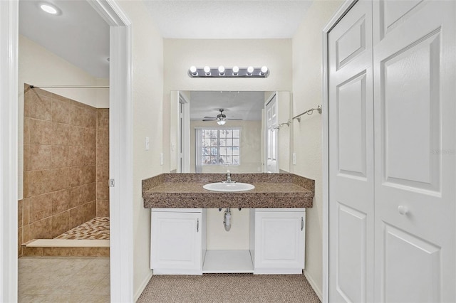 bathroom with sink and tiled shower