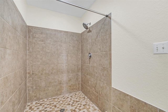 bathroom with tiled shower