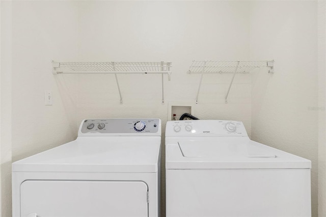 washroom with independent washer and dryer