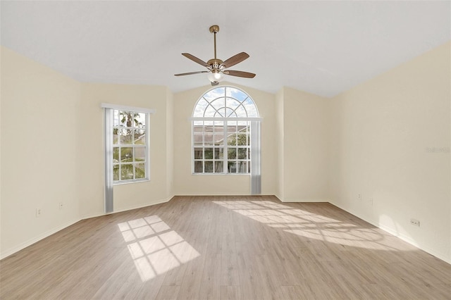 unfurnished room featuring light hardwood / wood-style floors, vaulted ceiling, and ceiling fan