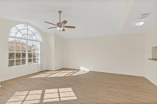 unfurnished room with ceiling fan, light hardwood / wood-style flooring, and vaulted ceiling