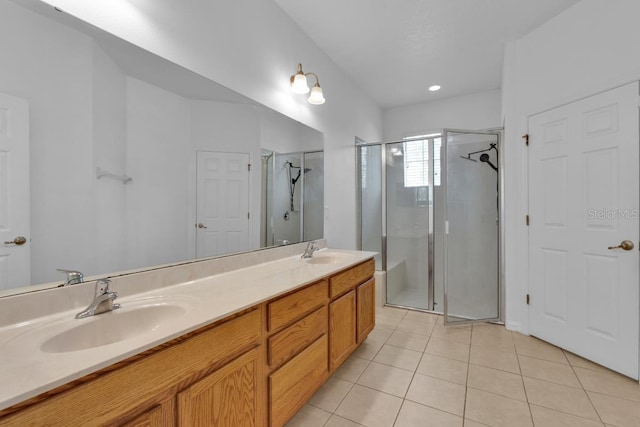 bathroom featuring vanity, tile patterned floors, and walk in shower