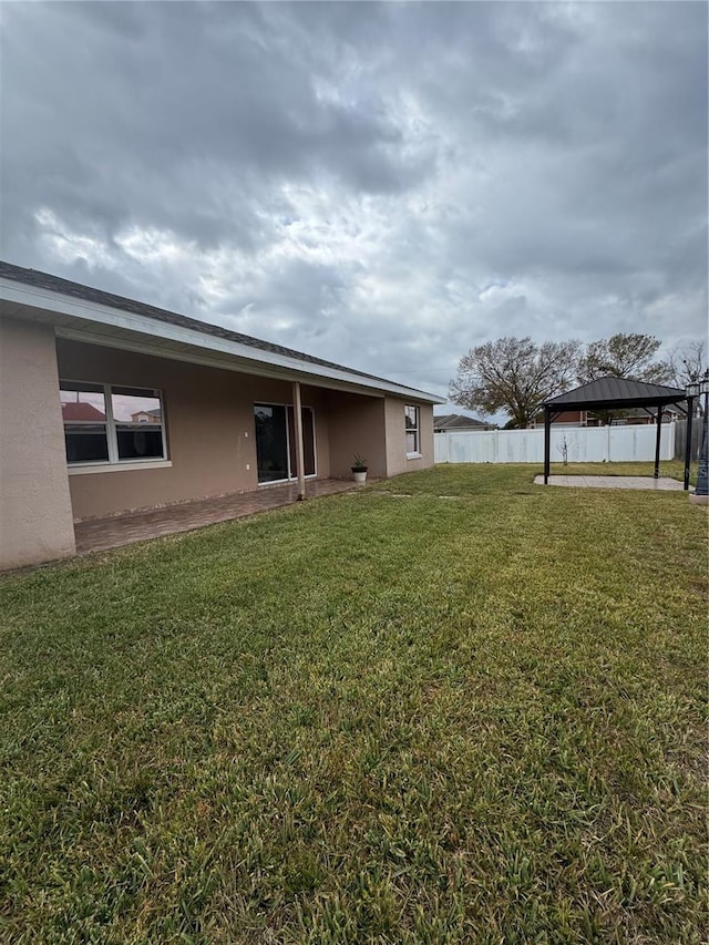 view of yard with fence and a gazebo