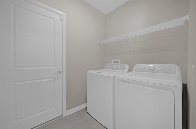 laundry area featuring light tile patterned floors and independent washer and dryer