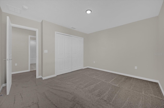 unfurnished bedroom featuring a closet and carpet flooring