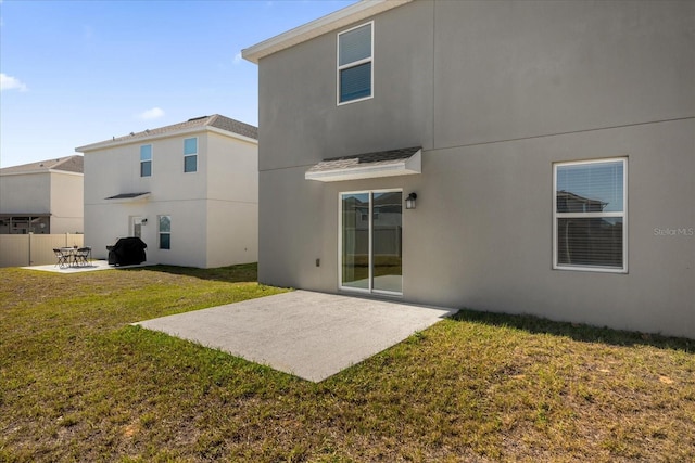 rear view of property featuring a patio area and a yard