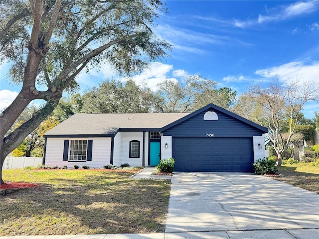 single story home with a garage and a front lawn