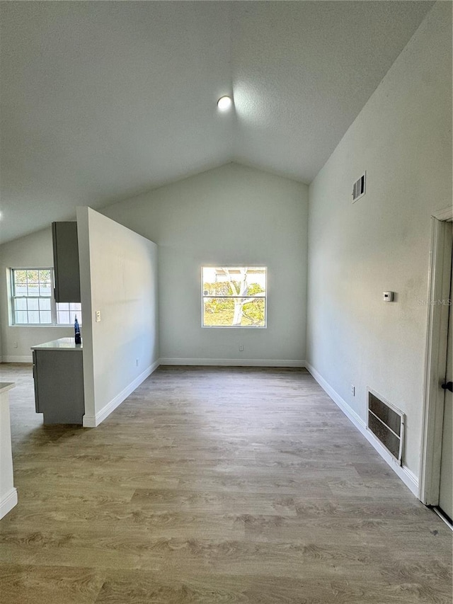 unfurnished living room with lofted ceiling and light hardwood / wood-style flooring