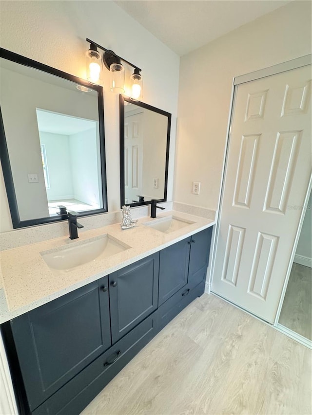 bathroom with vanity and hardwood / wood-style flooring