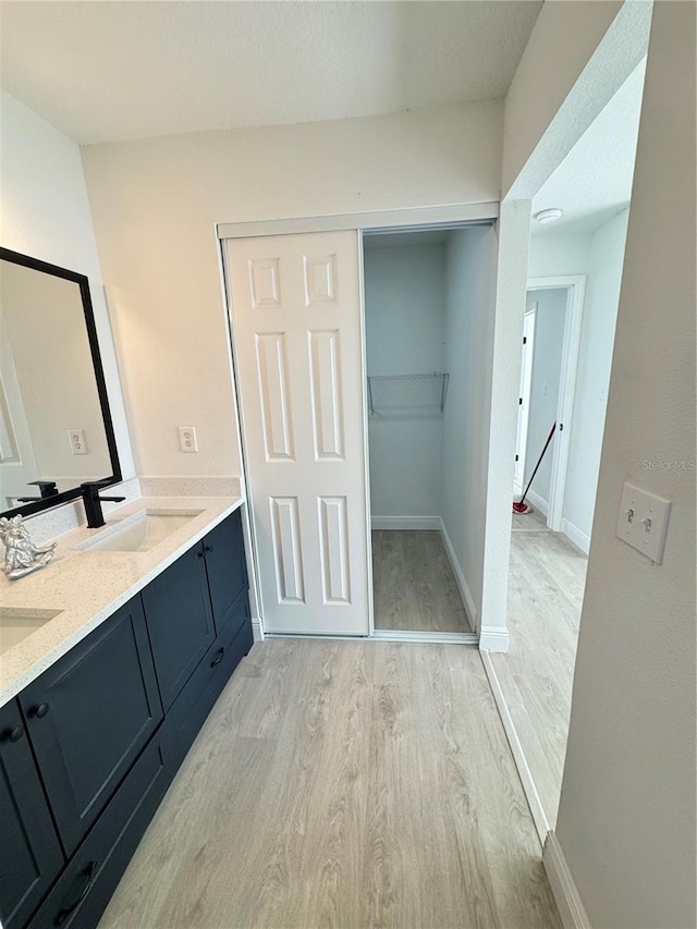 bathroom with vanity and wood-type flooring