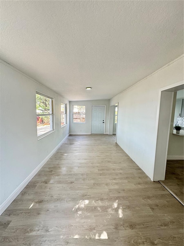 empty room featuring light hardwood / wood-style flooring and a textured ceiling