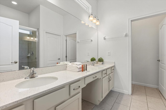 bathroom with vanity, a shower with door, and tile patterned flooring