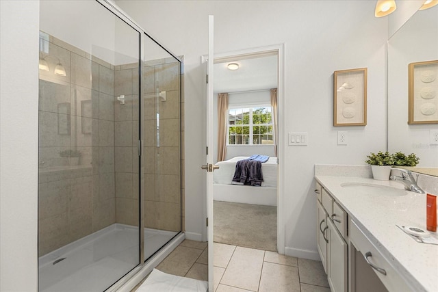 bathroom with a shower with door, tile patterned floors, and vanity