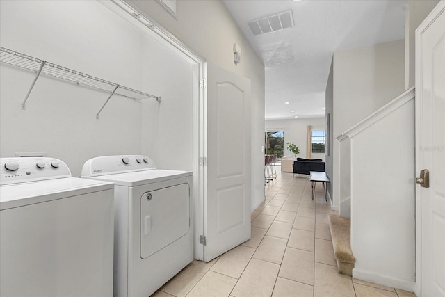 laundry room with light tile patterned floors and independent washer and dryer