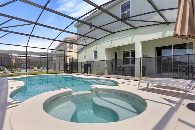 view of pool with an in ground hot tub, a lanai, and a patio