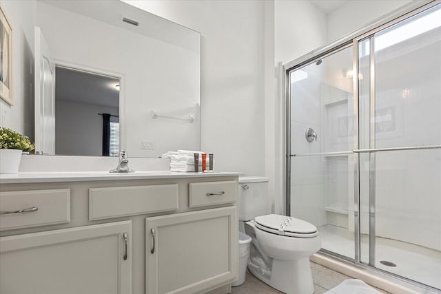 bathroom with vanity, toilet, and walk in shower