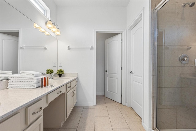 bathroom with an enclosed shower, vanity, and tile patterned flooring