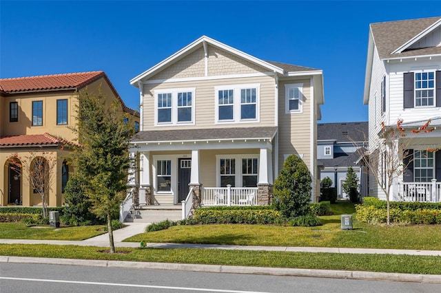 view of front of house with a front yard and a porch