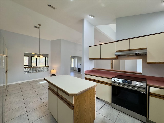 kitchen with pendant lighting, a center island, vaulted ceiling, electric range, and light tile patterned floors