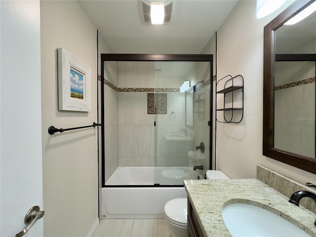 full bathroom with vanity, toilet, bath / shower combo with glass door, and tile patterned flooring