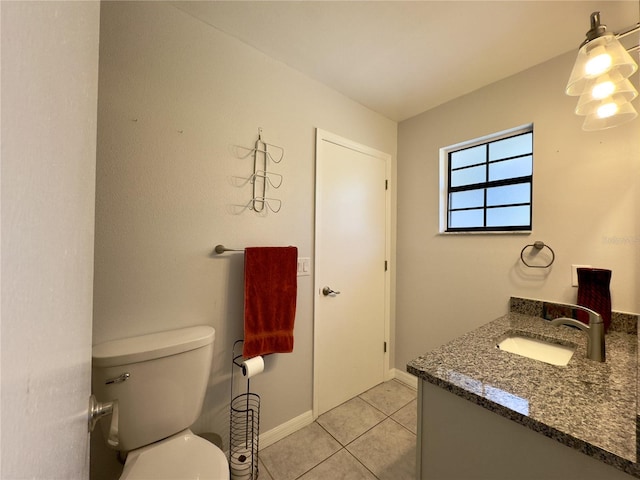 bathroom featuring tile patterned floors, vanity, and toilet