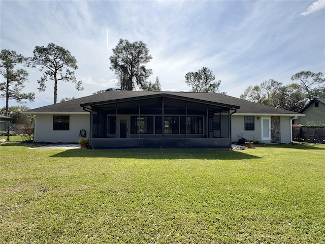 back of house with a yard and a sunroom