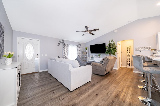 living room with vaulted ceiling, ceiling fan, and dark hardwood / wood-style flooring