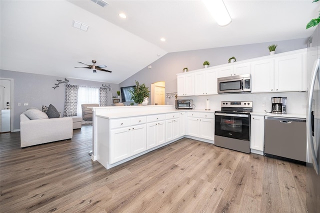 kitchen featuring white cabinetry, light hardwood / wood-style floors, kitchen peninsula, and appliances with stainless steel finishes