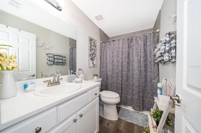 bathroom featuring hardwood / wood-style flooring, vanity, and toilet