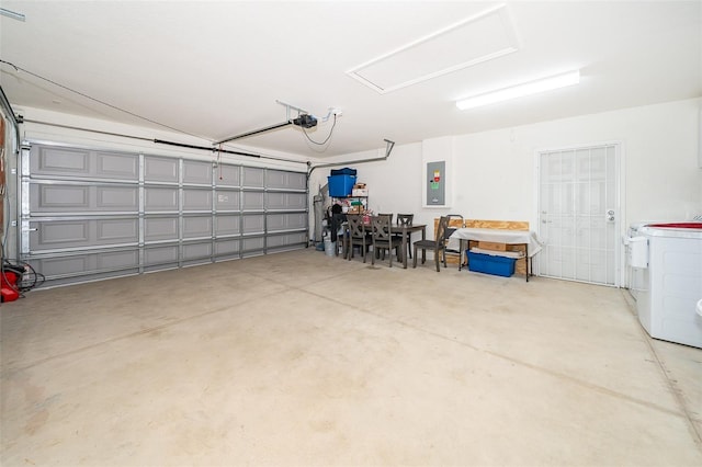 garage with a garage door opener and electric panel