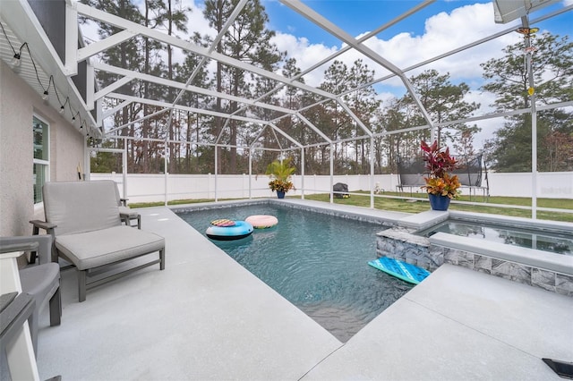 view of swimming pool with an in ground hot tub, a lanai, and a patio