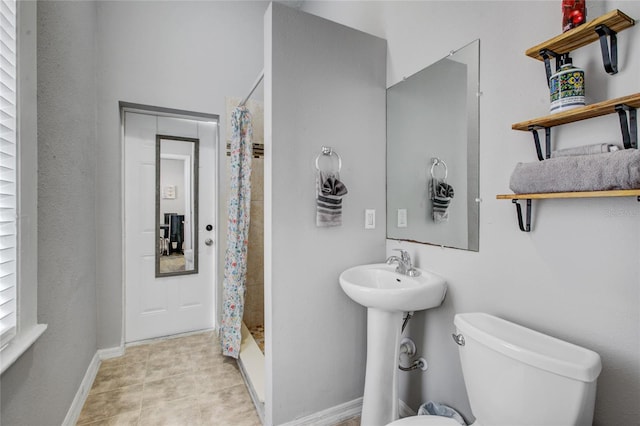 bathroom featuring toilet and walk in shower