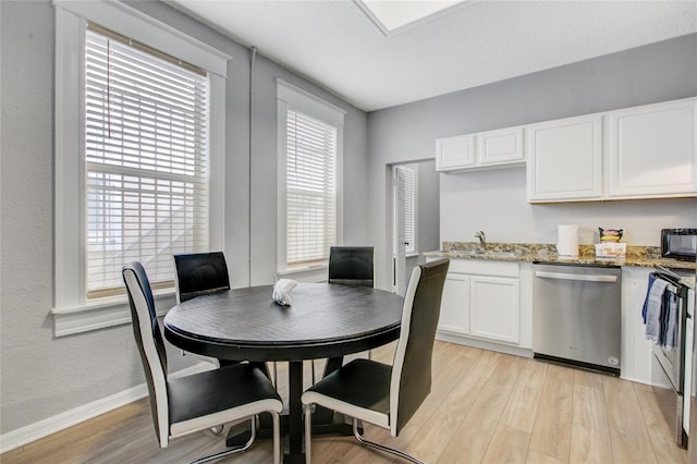 dining area featuring sink and light hardwood / wood-style flooring