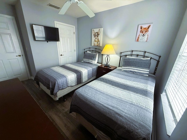 bedroom with wood-type flooring and ceiling fan